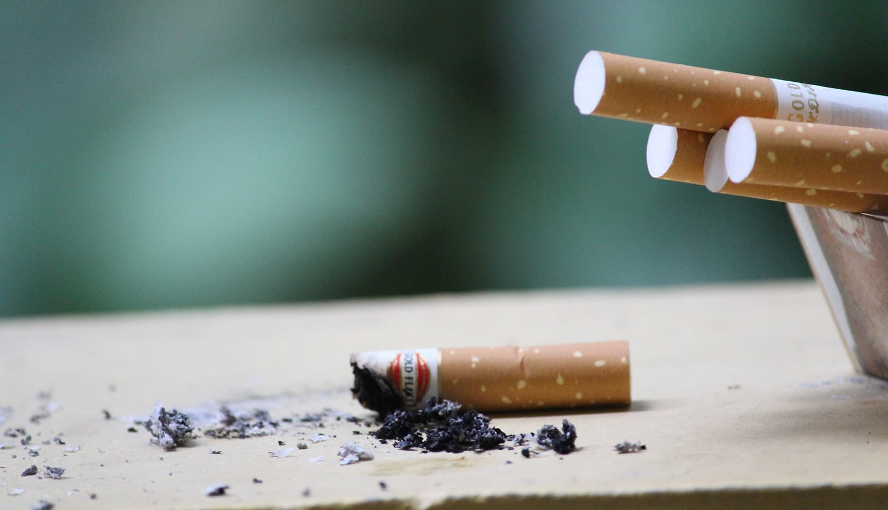 Cigarette smoke curling upward